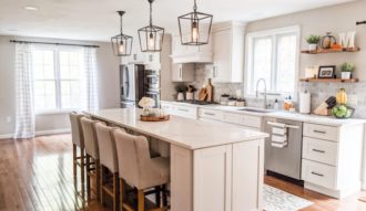 Open white kitchen with pendant lights